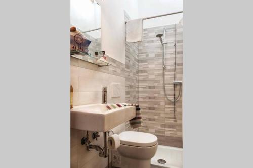 a bathroom with a sink and a toilet and a shower at Casa Letizia in Ponsacco