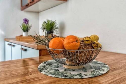 a bowl of oranges and bananas on a table at Casa Letizia in Ponsacco