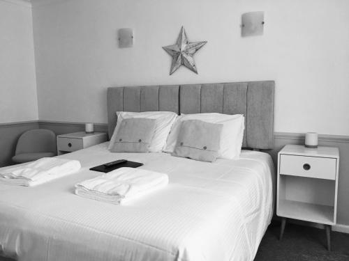 a black and white photo of a bedroom with a bed at Tregorran Guest House Mevagissey in Mevagissey