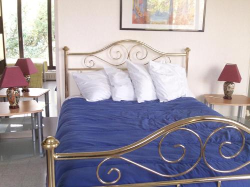 a bedroom with a bed with blue sheets and white pillows at Charleroi Marcinelle verdure et parking gratuit in Charleroi