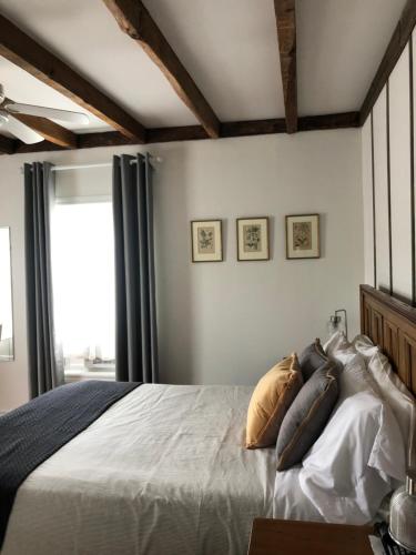 Un dormitorio con una cama grande con almohadas. en AUBERGE Knowlton, en Lac-Brome