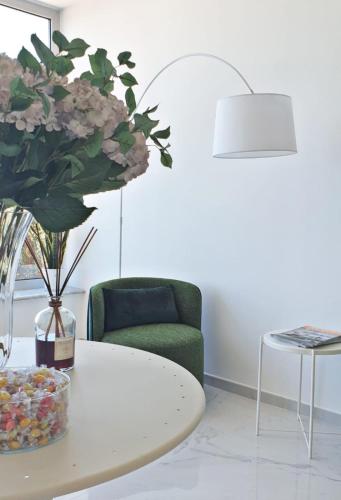a living room with a coffee table and a green chair at Tenuta Tropeano in Tropea