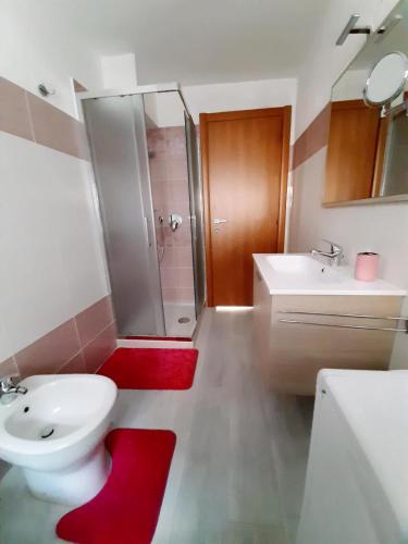 a bathroom with a toilet and a sink and a shower at La Maison de Joanna in Châtillon