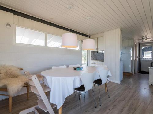 a dining room with a white table and chairs at 4 person holiday home in Fanø in Fanø