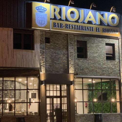 a bar with a sign on the front of a building at Hotel Riojano in Humanes de Madrid