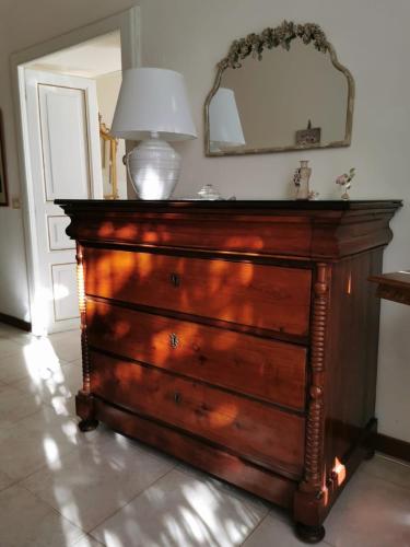 a dresser with a lamp on top of it at Oasi di Pace in Gaeta