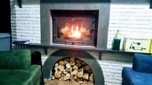 a brick fireplace with a fire in it at Villa15 Lodge, Five-Star Stay 5BD 5-5BA Beach Access Villa with Pool , Gym, Sauna, Alfresco Dining & Garden in Manavgat