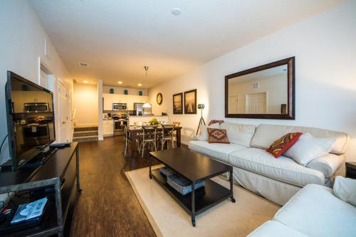 a living room with a couch and a table at HAPPY PORT, your home very close to entertainment in Kissimmee