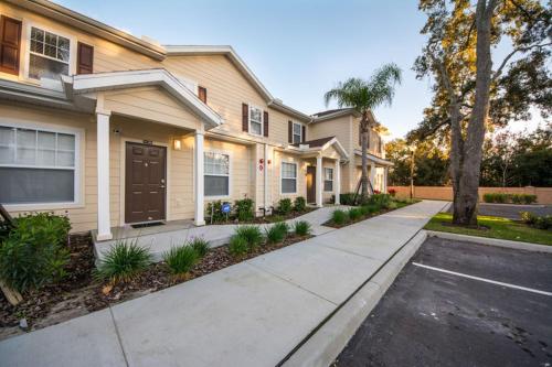 a house with a driveway in front of it at HAPPY PORT, your home very close to entertainment in Kissimmee