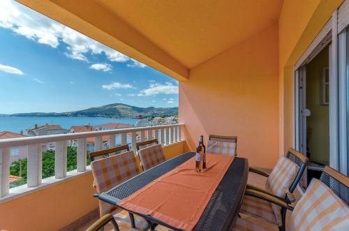 a balcony with a table and chairs and a view of the water at Apartments Melita in Trogir