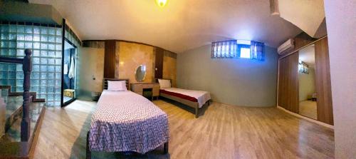 a room with a bed and a table and a window at Villa15 Lodge, Five-Star Stay 5BD 5-5BA Beach Access Villa with Pool , Gym, Sauna, Alfresco Dining & Garden in Manavgat