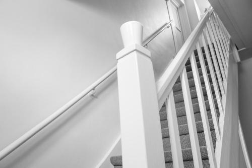 a staircase with white railings in a house at Auberge de Campveerse Toren in Veere