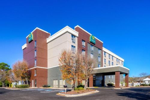 a large brick building with a tree in front of it at La Quinta Inn by Wyndham North Myrtle Beach in Myrtle Beach