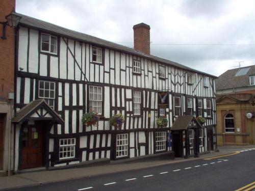 a black and white building on the side of a street at The Falcon Hotel in Bromyard