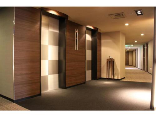 a hallway with wooden doors in a building at Hotel Il Credo Gifu - Vacation STAY 84631 in Gifu