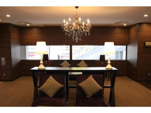 a dining room with a chandelier and a table with chairs at Hotel Il Credo Gifu - Vacation STAY 84636 in Gifu
