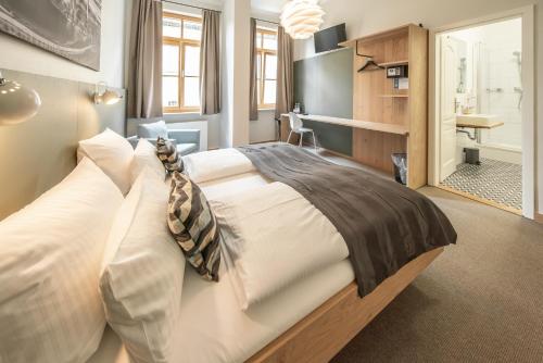 a bedroom with a large bed in a room at Hotel Am Markt in Munich