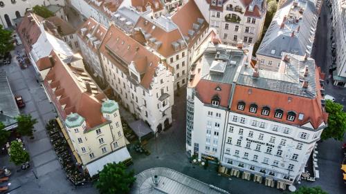 an overhead view of a city with tall buildings at Hotel Am Markt in Munich
