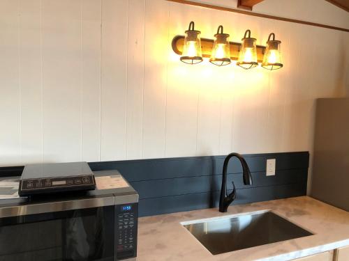 a kitchen with a sink and a microwave at Pacific Dunes Resort in Copalis Beach