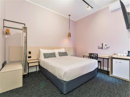 a hotel room with a bed and a desk at Nightcap at Belgian Beer Cafe in Perth