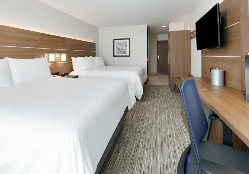 a hotel room with two beds and a television at Holiday Inn Express & Suites San Antonio NW near SeaWorld by IHG in San Antonio