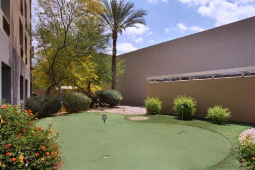 a green lawn with a lawn chair in front of a building at Holiday Inn Scottsdale North- Airpark, an IHG Hotel in Scottsdale