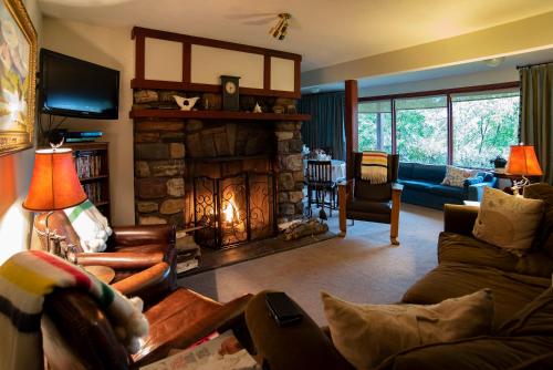 a living room with a fireplace and a couch at Northland Lodge in Waterton Park