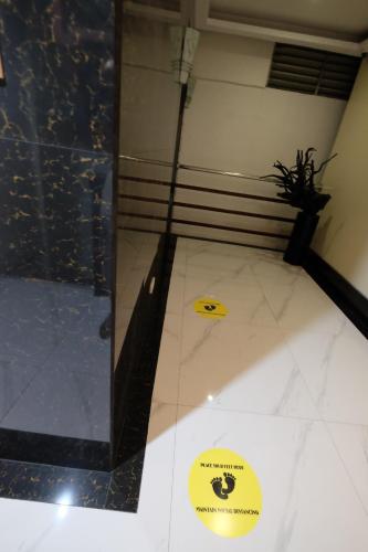 a room with two yellow stickers on the floor at Oriental Zen Suites in Manila