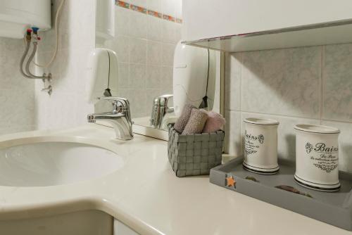 a bathroom counter with a sink and a mirror at Apartments Rikli Bled in Bled