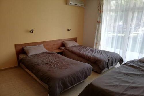 a bedroom with two beds and a window at Yves 2 Bed apart at Sun Village Sunny Beach not far away from the sea in Sunny Beach