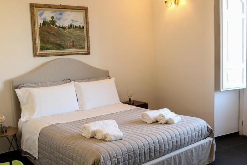 a bedroom with a bed with towels on it at Bed and Breakfast Terra del Sole Ibla in Ragusa