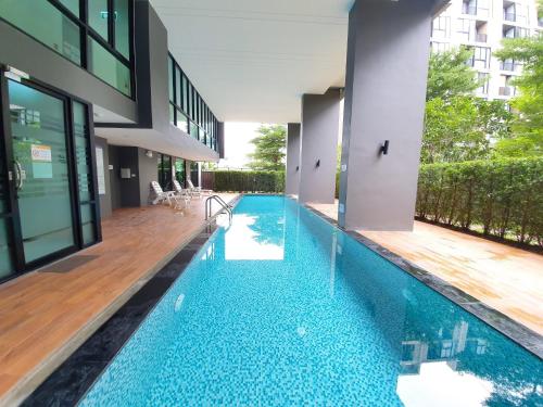 an infinity pool in a house with a building at Luxury Family Suite Two Bedroom At Nimman Maya 605RY in Chiang Mai