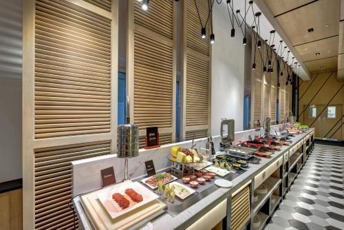 a buffet line with many different types of food at URBAN Al Khoory Hotel in Dubai