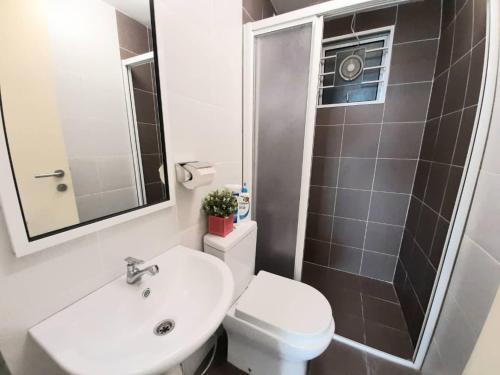 a bathroom with a toilet and a sink and a shower at Homey Galleria Suite A 10 12 in Seri Kembangan