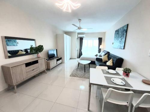 a living room with a couch and a table at Homey Galleria Suite A 10 12 in Seri Kembangan