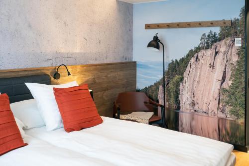 a bedroom with a bed with a mountain view at Original Sokos Hotel Vaakuna Kouvola in Kouvola