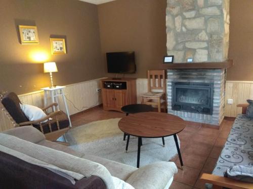 a living room with a couch and a fireplace at Rural Arco Iris in Cuenca