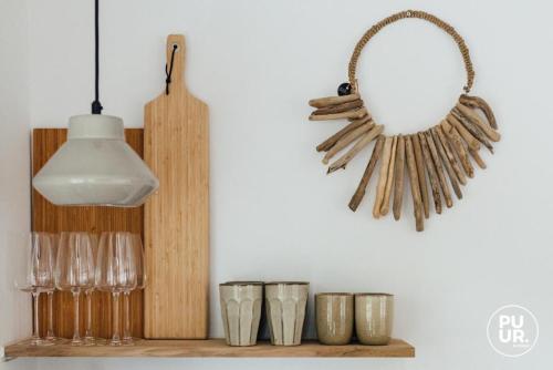 a shelf with glasses and a mirror and a light at nummer 100 - 2 in Leeuwarden