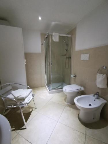 a bathroom with a shower and a toilet and a sink at da Rocco B&B in Sant'Isidoro