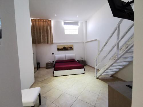 a bedroom with a bed and a staircase at da Rocco B&B in Sant'Isidoro