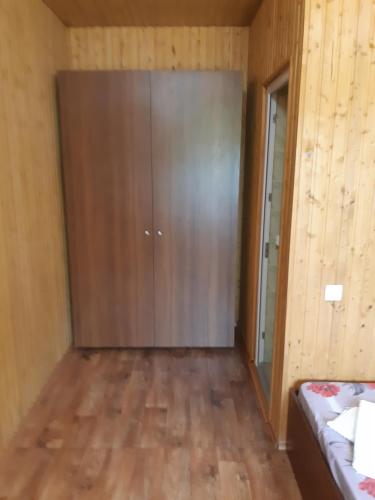 a large sliding door in a room with wooden floors at Отель Маленький Рай in Zatoka