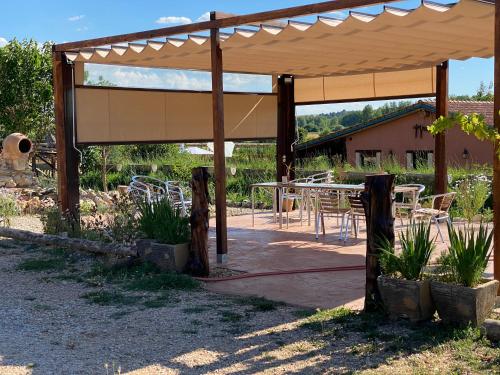 a wooden pavilion with a table and chairs at El BURGO DE OSMA ALOJAMIENTO RURAL VILLA BAGH in El Burgo de Osma