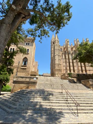 a large building with stairs in front of it at Vila Damunt in Palma de Mallorca