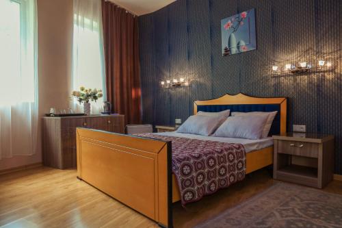 a hotel room with a bed and a table at Hotel Borjomi Aisi in Borjomi