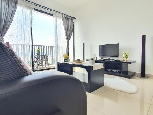 a living room with a couch and a television at I-City Shah Alam by BeeStay Management in Shah Alam