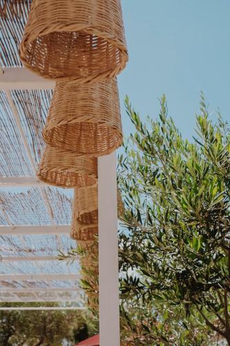a pole with a straw hat on top of it at Oustau Camarguen Hôtel & Spa in Le Grau-du-Roi
