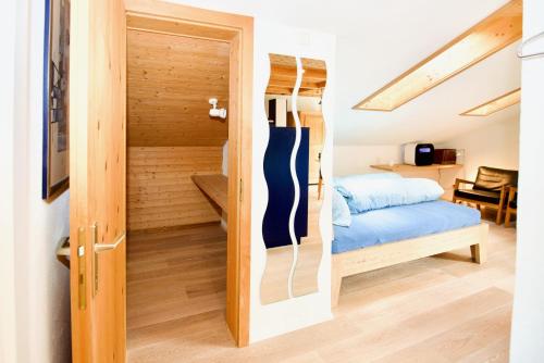 a room with a door leading to a bedroom at Stilvolle Dachwohnung für 4 im Thermenort Vals in Vals