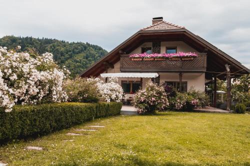 a house with pink flowers on top of it at Vintgar studio in Zgornje Gorje