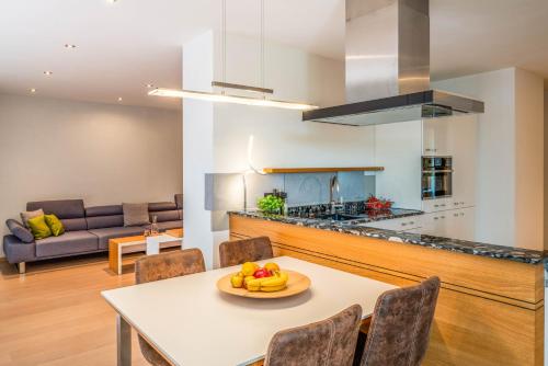 a kitchen and living room with a table and chairs at Lebensart am See in Bad Endorf