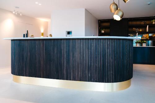 a black bar in a room with a counter at Hotel du Bassin in Ostend